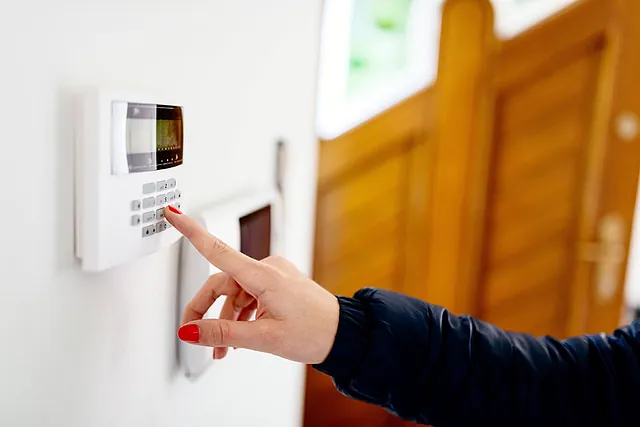 woman setting domestic alarm